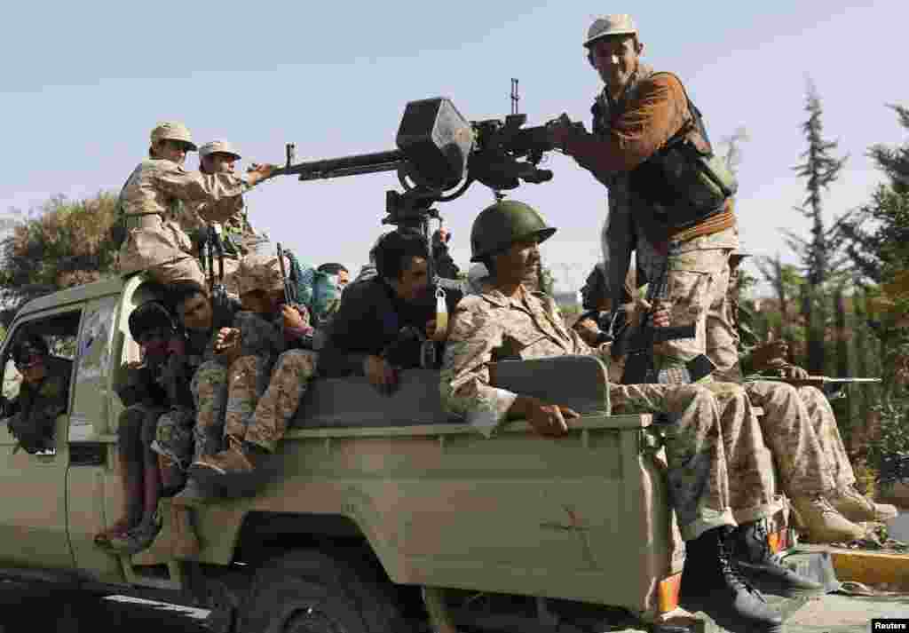 Houthi rebel fighters ride a truck while patrolling a street in Sana'a, Yemen, Jan. 21, 2015. 