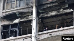 Fire inspectors view damage after a fire broke out at the Taipei Hospital, causing multiple deaths, in New Taipei City, Taiwan August 13, 2018. 