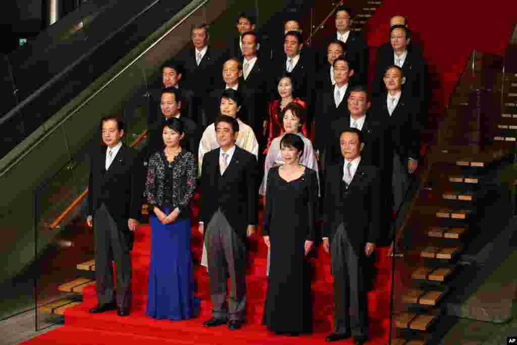 Japan&#39;s Prime Minister Shinzo Abe (front row center) and his new cabinet members pose for a group photo following the first cabinet meeting at the prime minister&#39;s official residence, in Tokyo, Sept. 3, 2014.