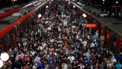 People walk after disembarking from a train at Luz station amid the outbreak of the coronavirus disease (COVID-19) and after Omicron has become the dominant coronavirus variant in the country, in Sao Paulo, Brazil January 12, 2022.