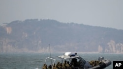 South Korean navy sailors in a speed boat patrol around South Korea's western Yeonpyong Island after finishing their exercise, near the disputed sea border with North Korea, February 20, 2012.