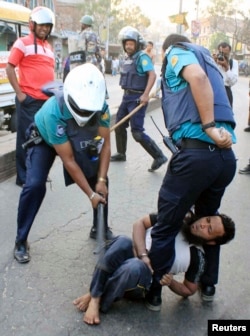 A policeman uses a baton on an activist of Jamaat-e-Islami, Bangladesh's biggest Islamist party, during a clash at Jatrabari in Dhaka, Feb. 28, 2013.