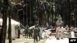Soldiers from the Bangladesh Army erect tents at the torched Lal Ching Buddhist temple at Ramu, some 350 kilometers (216 miles) from the capital Dhaka, October 1, 2012.