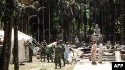 Soldiers from the Bangladesh Army erect tents at the torched Lal Ching Buddhist temple at Ramu, some 350 kilometers from the capital Dhaka, October 1, 2012.