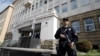 Policajac ispred zgrade Specijalnog suda u Beogradu, ilustracija