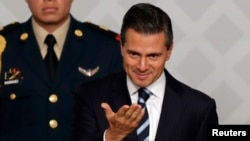 Mexico's President Enrique Pena Nieto gestures during an event with lawyers in Mexico City, Nov. 21, 2014. 