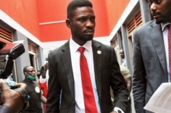 FILE - Bobi Wine, center, arrives to speak at the National Unity Platform head office in Kampala, Uganda, Aug. 31, 2020.