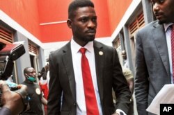 FILE - Bobi Wine, center, arrives to speak at the National Unity Platform head office in Kampala, Uganda, Aug. 31, 2020.