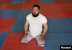 FILE - Abdul Hanan, 34, a wounded soldier from Afghanistan's National Army (ANA) looks on during his practic for Invictus Games competition, at the Kabul Military Training Center (KMTC) in Kabul, Afghanistan, July 4, 2017.