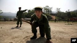 In this photo taken April 17, 2010, recruits of the Kachin Independence Army, one of Burma's largest armed ethnic groups, go through battle drills at a training camp near Laiza, Burma.