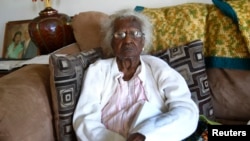 FILE - Jeralean Talley sits on her couch for a photograph during her 115th birthday in her home in Inkster, Michigan, May 23, 2014.