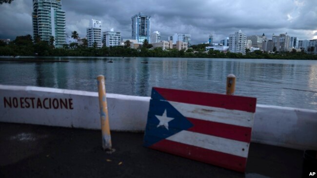 FILE - A wooden Puerto Rican flag is displayed on the dock of the Condado lagoon in San Juan, Puerto Rico, Sept. 30, 2021.