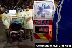 U.S. Navy Sailors prepare to transport a patient arriving for medical treatment from an ambulance onto the hospital ship USNS Comfort in New York City, April 9, 2020.
