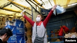 A vendor sells face masks to protect against the coronavirus, in a market in La Paz, Bolivia, March 11, 2020. 