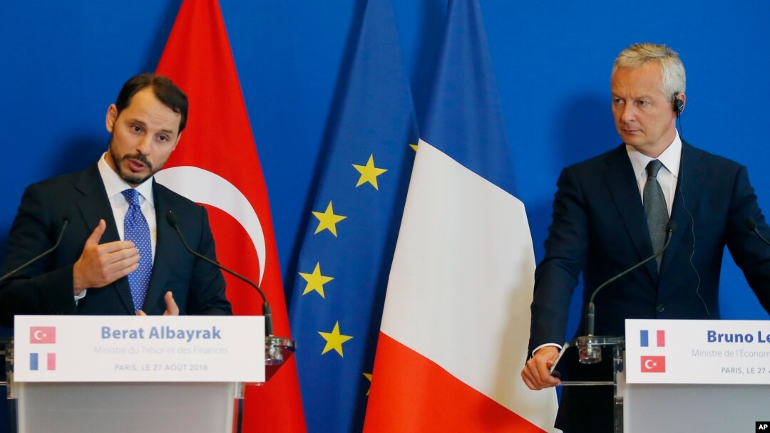 Turkey's Treasury and Finance Minister Berat Albayrak, left, and France's Finance Minister Bruno Le Maire make declarations to the media at the ministry in Paris, France, Aug. 27, 2018.