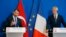 FILE - Turkey's Treasury and Finance Minister Berat Albayrak, left, and France's Finance Minister Bruno Le Maire make declarations to the media at the ministry in Paris, France, Aug. 27, 2018.
