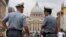  Italian financial police officers talk to each other in front of St. Peter's square at the Vatican, September 2010.