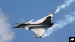 FILE - A Rafale single-seat jet aircraft flies during the Paris Air Show, in Le Bourget airport, north of Paris, June 19, 2015.