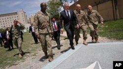 U.S. Defense Secretary James Mattis, third right, walks with U.S. Army Command Sergeant Major David Clark, left, and General Christopher Haas, second right, as he arrives to the Resolute Support headquarters in Kabul, Afghanistan, April 24, 2017. 