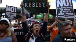 FILE - People protest U.S. President Donald Trump's announcement that he plans to reinstate a ban on transgender individuals from serving in any capacity in the U.S. military, in Times Square, in New York City, New York, U.S., July 26, 2017. 