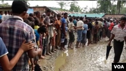 Rohingya refugees line up for water at a refugee camp near Cox’s Bazaar, Bangladesh. 