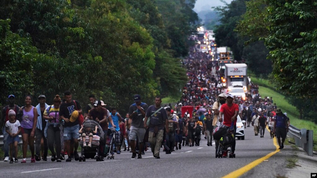 FILE - Migrants walk along the highway toward the municipality of Escuintla, Chiapas state, Mexico, Oct. 28, 2021, as they continue their journey toward the northern states of Mexico and the US border. 