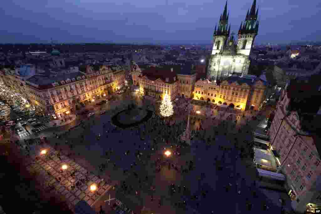 A Christmas tree illuminates the Old Town Square in Prague, Czech Republic, Nov. 28, 2020.