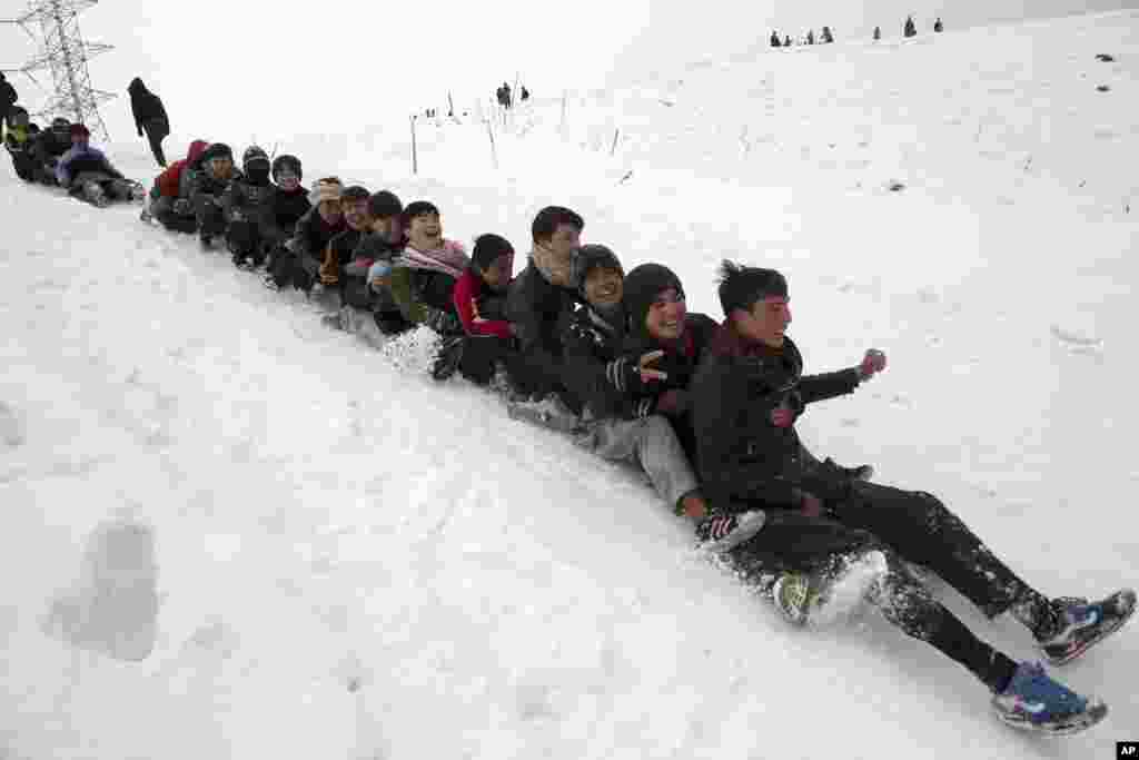 Children play in the snow in Kabul, Afghanistan.