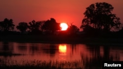 The sun sets over the Okavango Delta, Botswana, April 25, 2018. 