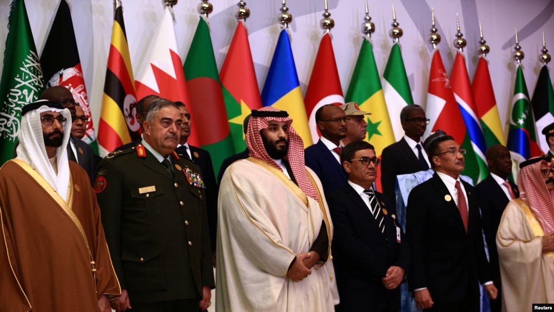 Putra mahkota Saudi Mohammed bin Salman (tengah) berfoto dengan kepala staf koalisi militer negara Islam kontra terorisme di Riyadh, 26 Noveber 2017. 