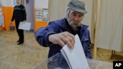 A man casts his vote, in Sofia, Bulgaria, March 26, 2017.