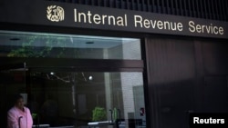 A woman walks out of the Internal Revenue Service building in New York, May 13, 2013.