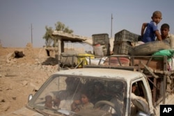 Civilians flee villages outside Mosul a day after Iraqi Kurdish forces launched an operation east of the Islamic State-held city in Iraq, Aug. 15, 2016. The Kurdish forces known as the Peshmerga say they have retaken 12 villages in the operation in an effort to encircle the city.