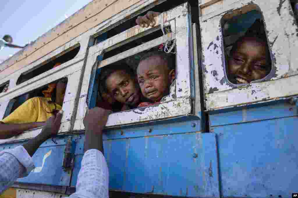 Tigray refugees who fled the conflict in the Ethiopia&#39;s Tigray, ride a bus going to the Village 8 temporary shelter, near the Sudan-Ethiopia border, in Hamdayet, eastern Sudan.