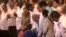 Cuban Leader Fidel Castro, center, talks with a girl during a gala for his 90th birthday at the 'Karl Marx' theater in Havana, Cuba, Saturday, Aug. 13, 2016. 