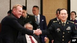 Acting U.S. Secretary of Defense Patrick Shanahan, left, shakes hands with Chinese Minister of National Defense Gen. Wei Fenghe on the sidelines of the 18th International Institute for Strategic Studies Shangri-la Dialogue, Singapore, June 1, 2019. 