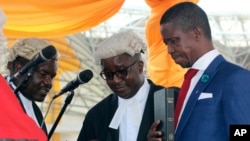 FILE - The Patriotic Front's Edgar Lungu, right, is sworn in as president at an inauguration ceremony in Lusaka, Jan. 25, 2015. Lungu says he will nominate a female vice presidential running mate for his re-election bid in the August 11, 2016, general election. 