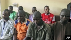 Men believed to be members of Islamist sect Boko Haram are suspected of being involved in a series of bomb attacks, wait for the start of a court session at the Wuse magistrate court in Nigeria's capital Abuja, September 13, 2011.