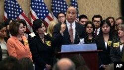 FILE - Sen. Cory Booker, D-N.J., center, speaks during a news conference on Capitol Hill in Washington, Jan. 30, 2018, about legislation to protect Deferred Action for Childhood Arrivals (DACA) program recipients.