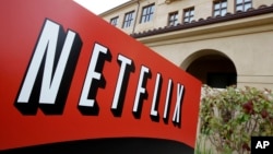 FILE - A sign points to Netfilx headquarters in Los Gatos, Calif. Netflix.