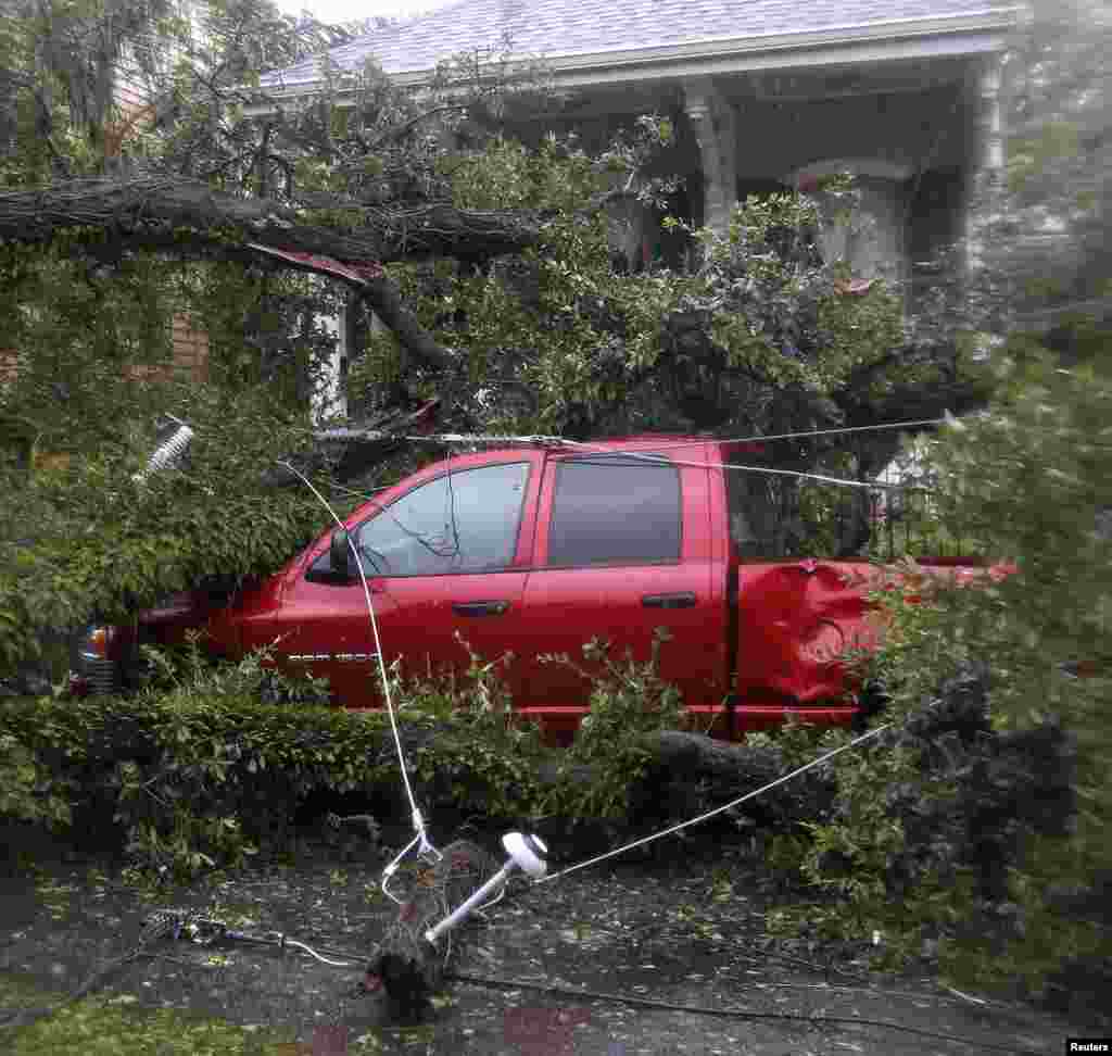 Downed trees and power lines are seen on top of a pickup truck as Hurricane Isaac passes through New Orleans, Louisiana, August 29, 2012. 