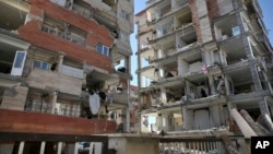 Buildings are damaged by an earthquake in a compound which was built under the Mehr state-owned program, in Sarpol-e-Zahab in western Iran, Nov. 14, 2017. 