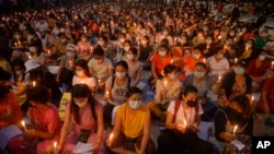 FILE - Protesters attend a candlelight night rally in Yangon, Myanmar, March 13, 2021. Until mid-2021, there were many strike groups conducting flash mob protests but now only 10 have survived, strike groups said. 