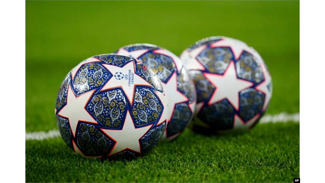 FILE - The Official UEFA Champions League match balls lie on the pitch ahead of the Champions League, round of 16, first leg football match between Liverpool and Real Madrid at the Anfield stadium in Liverpool, England, on Feb. 21, 2023.