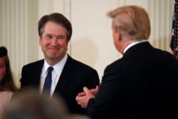 Supreme Court nominee Judge Brett Kavanaugh smiles next to U.S. President Donald Trump in the East Room of the White House in Washington, July 9, 2018