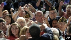 President Barack Obama greets the crowd after speaking at the 113th National Convention of the Veterans of Foreign Wars in Reno, Nevada, July 23, 2012. 