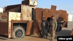 Kurdish Peshmerga commanders display on Dec. 23, 2015, heavily-fortified military equipment seized from IS during earlier battles.