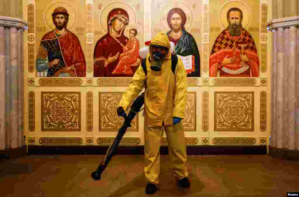 A specialist wearing personal protective equipment sanitizes a chapel inside the building of the Leningradsky railway station amid the outbreak of the COVID-19 in Moscow, Russia.