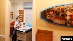 El Dr. Greg Gulbransen participa en una llamada de telemedicina con un paciente, mientras mantiene visitas tanto a sus pacientes habituales como a los confirmados, que tienen la enfermedad por coronavirus (COVID-19) en su consulta pediátrica en Oyster Bay, Nueva York.