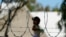 FILE - A child plays at a camp for asylum seekers stuck on America's doorstep, in Matamoros, Mexico, Nov. 18, 2020. 
